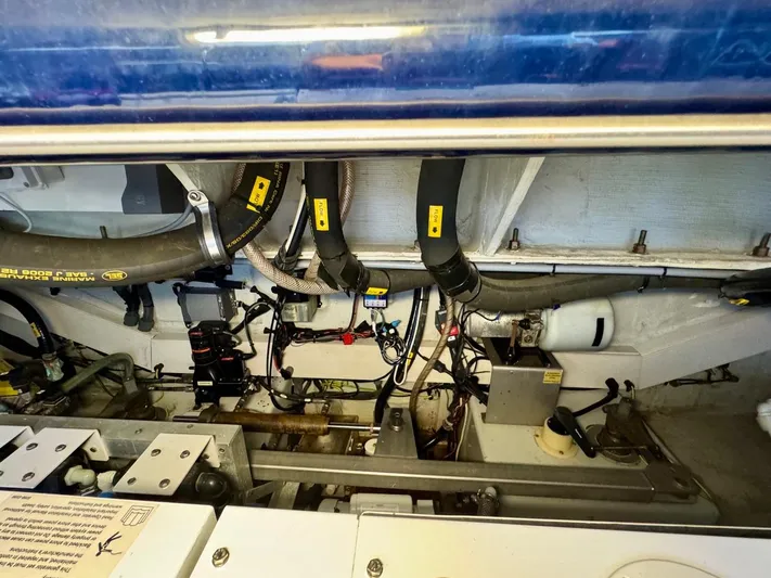 Tangerine Moon Yacht Photos Pics Engine room of 2014 Azimut Magellano 43 yacht, showcasing hoses and mechanical components.