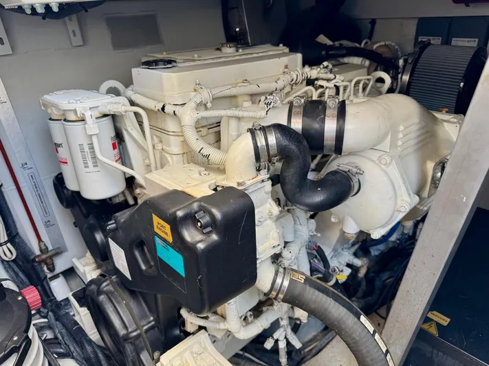 Tangerine Moon Yacht Photos Pics Engine compartment of 2014 Azimut Magellano 43 yacht, showcasing detailed mechanical components.