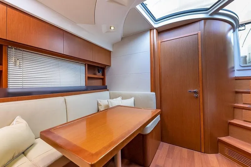 Alegria Yacht Photos Pics Luxurious interior of 2015 Beneteau Gran Turismo 44 yacht with wooden finishes and seating area.