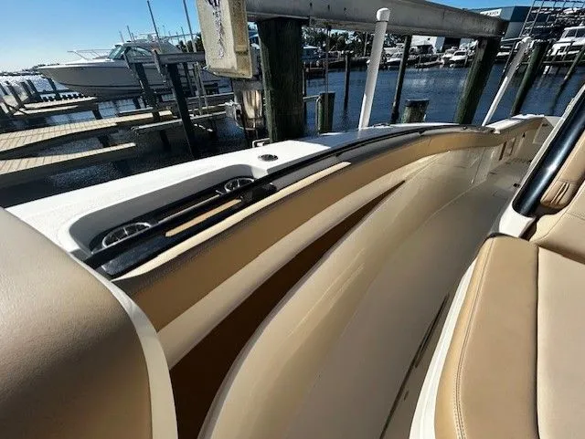  Yacht Photos Pics Scout 305 LXF 2022 boat, interior view with beige seats at dock.