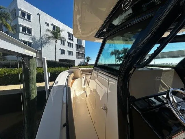  Yacht Photos Pics Scout 305 LXF 2022 boat docked near modern building.