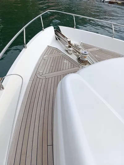  Yacht Photos Pics 2005 Pershing 76 yacht deck with sleek design and wood finish on calm water.