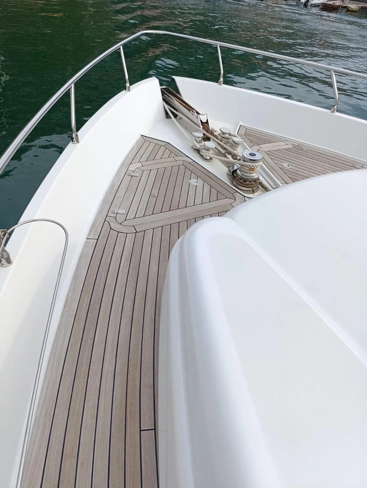 2005 Pershing 76 yacht deck with sleek design and wood finish on calm water.