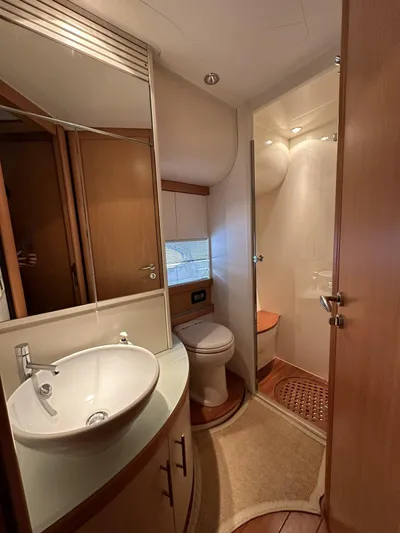  Yacht Photos Pics Luxurious bathroom in 2005 Pershing 76 yacht with modern fixtures and elegant design.