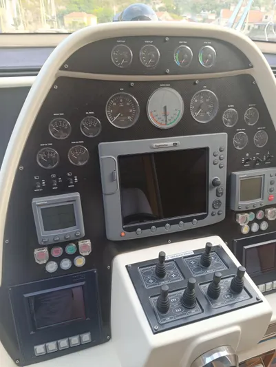  Yacht Photos Pics Control panel of a 2005 Pershing 76 yacht with gauges and navigation equipment.