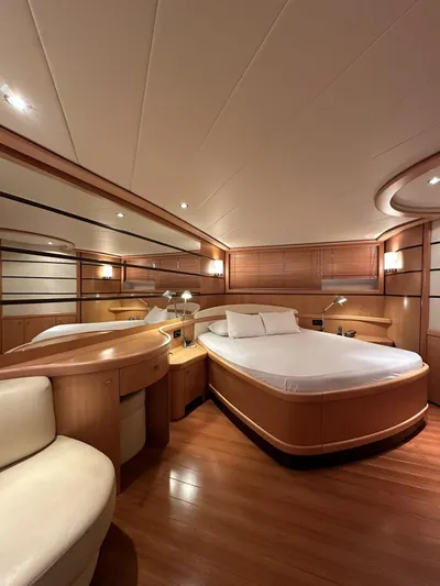  Yacht Photos Pics Luxurious cabin interior of a 2005 Pershing 76 yacht with elegant wood finishes.