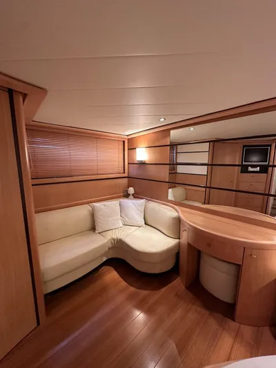  Yacht Photos Pics Luxurious interior of a 2005 Pershing 76 yacht with elegant wood finishes and cozy seating.