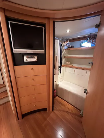  Yacht Photos Pics Interior of 2005 Pershing 76 yacht with TV, storage drawers, and closet space.