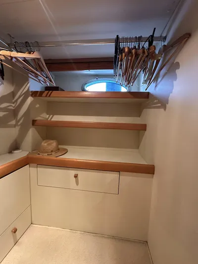  Yacht Photos Pics Interior of 2005 Pershing 76 yacht with wooden shelves and hangers.