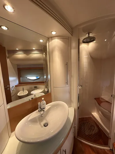  Yacht Photos Pics Luxurious bathroom in a 2005 Pershing 76 yacht with modern fixtures and elegant design.