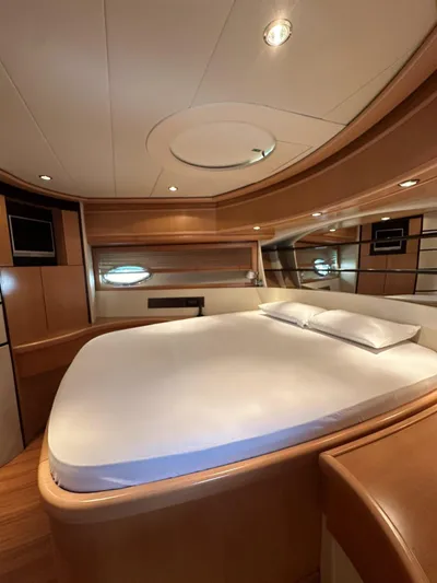  Yacht Photos Pics Luxurious bedroom interior of a 2005 Pershing 76 yacht with modern design and cozy ambiance.