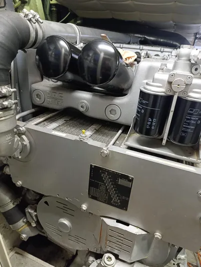  Yacht Photos Pics Engine compartment of a 2005 Pershing 76 yacht, showcasing mechanical components and filters.