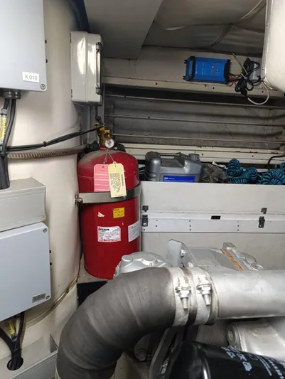  Yacht Photos Pics Engine room of 2005 Pershing 76 yacht with fire extinguisher and equipment.