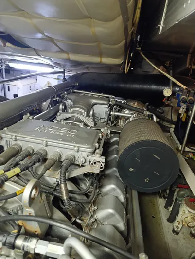  Yacht Photos Pics Engine room of a 2005 Pershing 76 yacht, showcasing mechanical components and wiring.