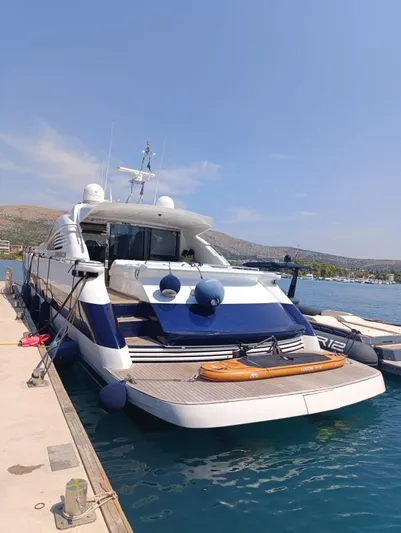 Yacht Photos Pics Luxury 2005 Pershing 76 yacht docked at marina under clear blue sky.