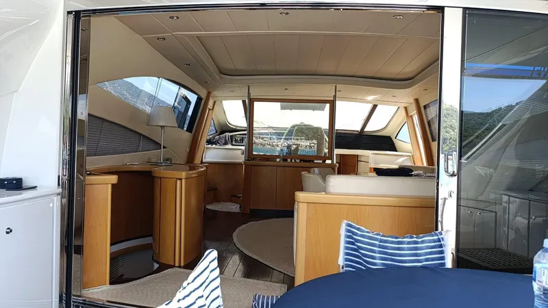  Yacht Photos Pics Luxurious interior of a 2005 Pershing 76 yacht with elegant wood finishes and modern design.