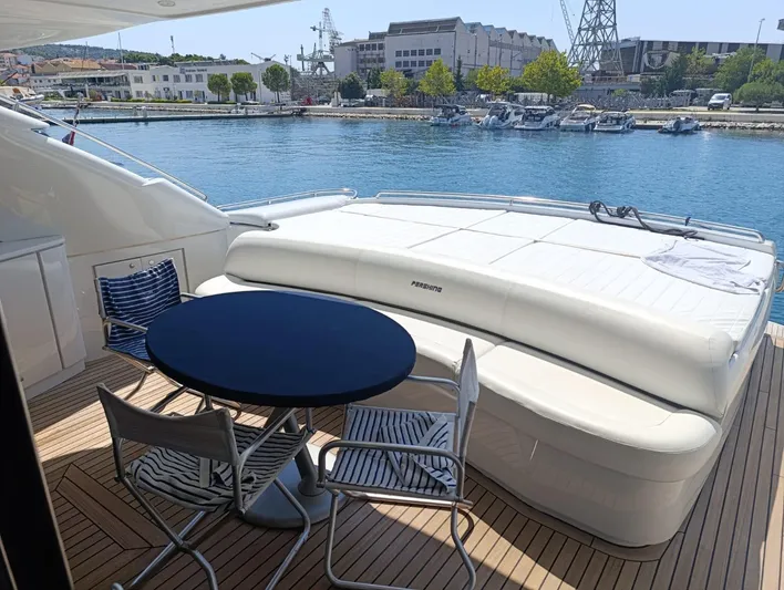  Yacht Photos Pics Luxury deck of 2005 Pershing 76 yacht with seating and waterfront view.