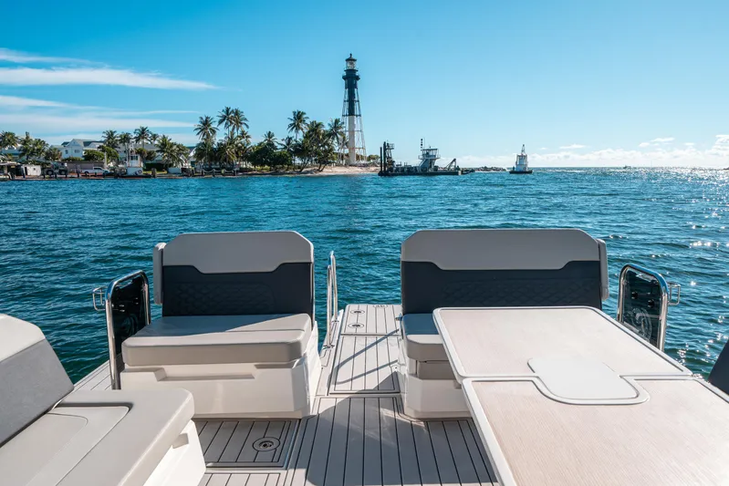 Era Ora Yacht Photos Pics Aquila 32 Sport 2022 boat with ocean view and distant lighthouse.