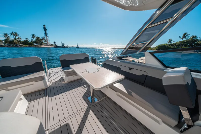 Era Ora Yacht Photos Pics Aquila 32 Sport 2022 yacht interior with ocean view and island backdrop.