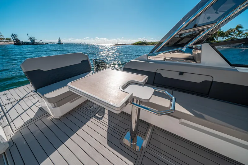 Era Ora Yacht Photos Pics Aquila 32 Sport 2022 boat interior with seating and table, ocean view.