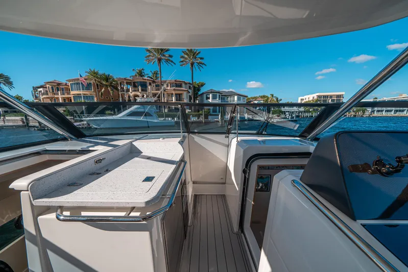 Era Ora Yacht Photos Pics Aquila 32 Sport 2022 yacht interior with waterfront view and luxury homes.