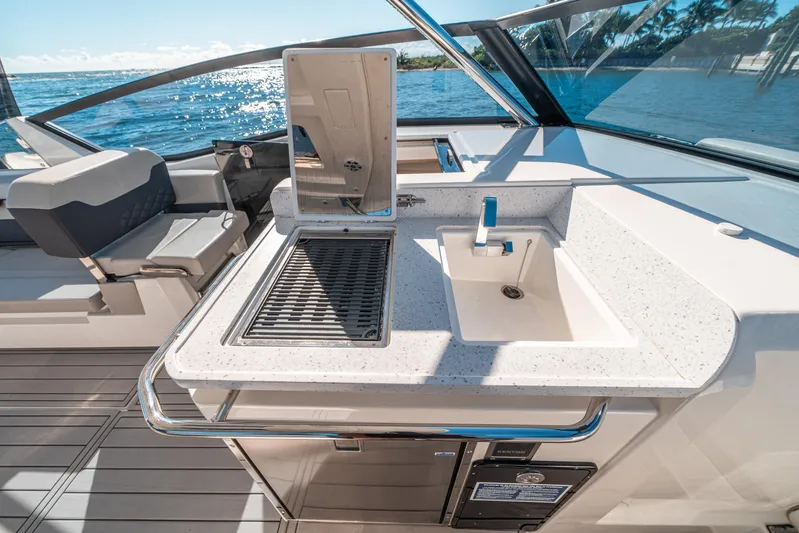 Era Ora Yacht Photos Pics Aquila 32 Sport 2022 yacht with sleek outdoor kitchen and ocean view.