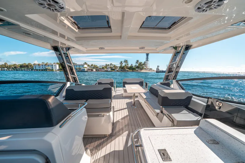 Era Ora Yacht Photos Pics Luxurious 2022 Aquila 32 Sport yacht interior with ocean view and modern seating.