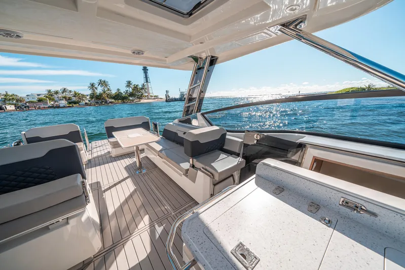 Era Ora Yacht Photos Pics Luxurious 2022 Aquila 32 Sport yacht interior with ocean view and modern seating.