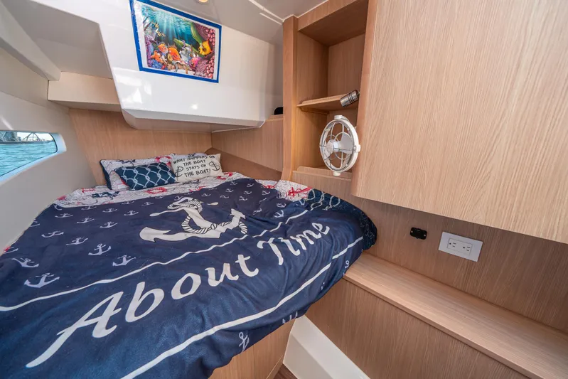 Era Ora Yacht Photos Pics Cozy cabin interior of 2022 Aquila 32 Sport with nautical-themed bedding.