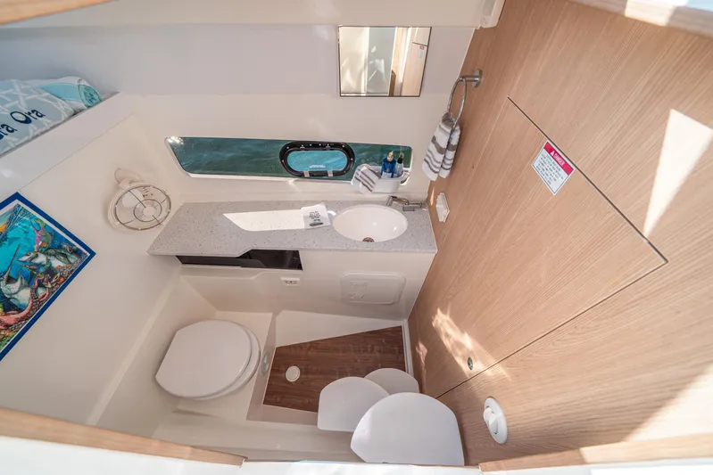 Era Ora Yacht Photos Pics Modern bathroom interior of 2022 Aquila 32 Sport yacht, featuring sink, toilet, and window.