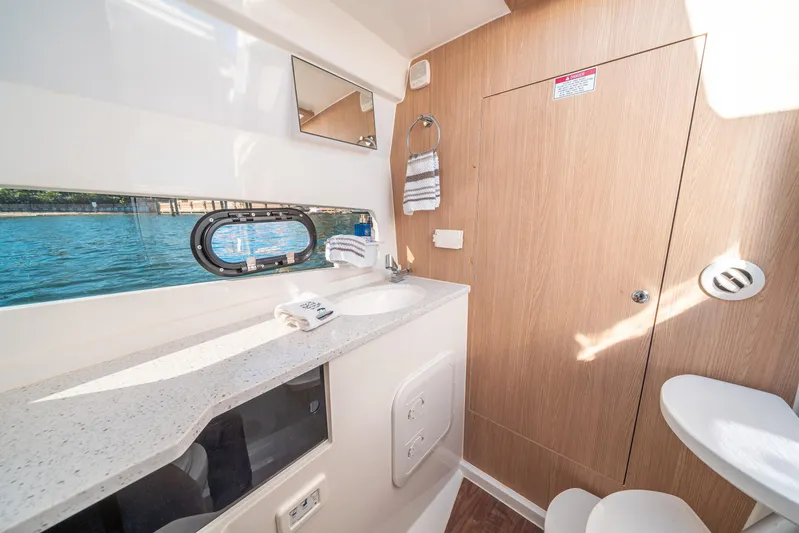 Era Ora Yacht Photos Pics Interior of 2022 Aquila 32 Sport yacht bathroom with window view and modern amenities.