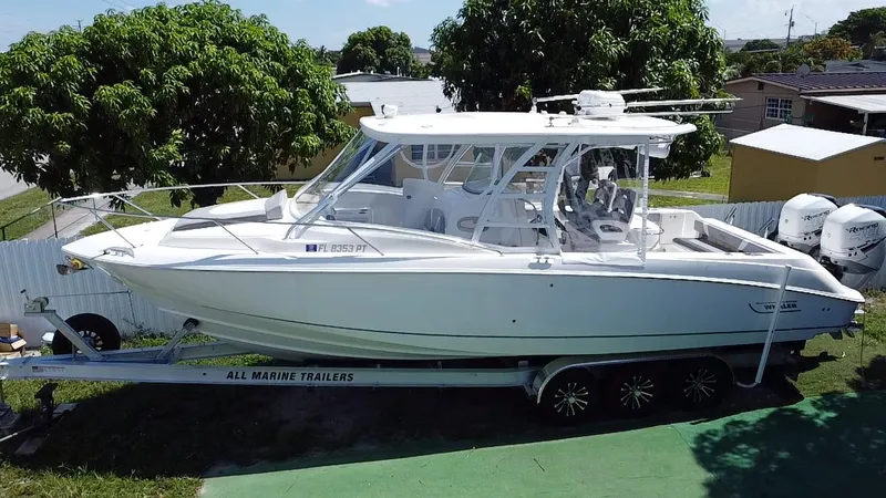  Yacht Photos Pics 2007 Boston Whaler 320 Outrage Cuddy Cabin on trailer, parked outdoors.