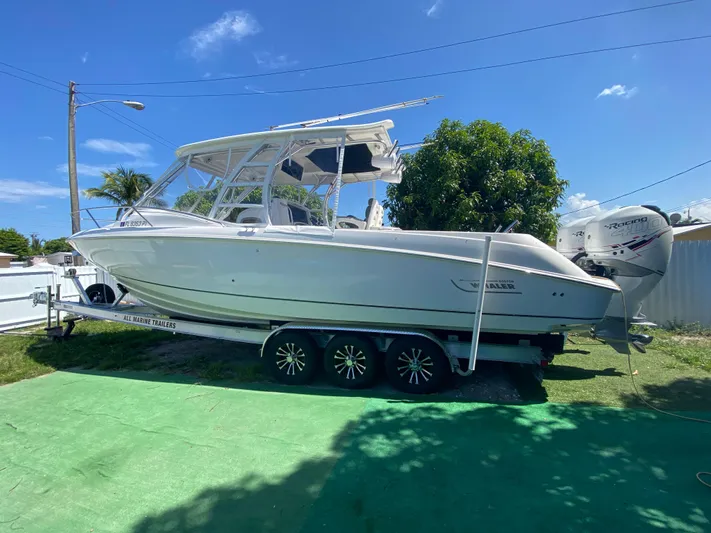  Yacht Photos Pics 2007 Boston Whaler 320 Outrage Cuddy Cabin on trailer, sunny day, green grass.