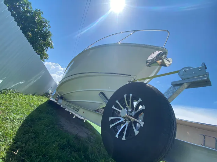  Yacht Photos Pics 2007 Boston Whaler 320 Outrage Cuddy Cabin on trailer under bright sun.