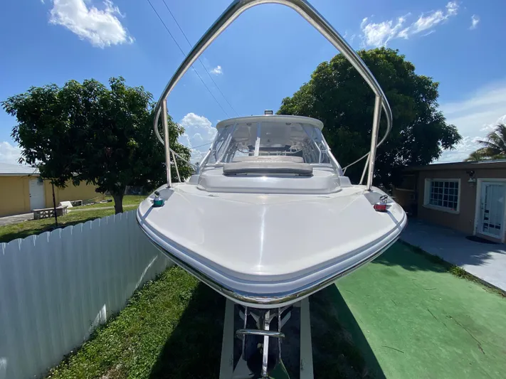  Yacht Photos Pics 2007 Boston Whaler 320 Outrage Cuddy Cabin boat on display, sunny day, residential background.