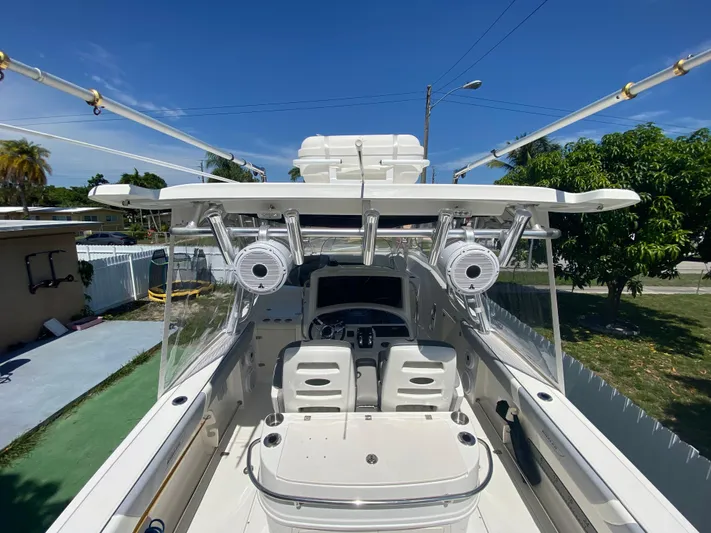  Yacht Photos Pics 2007 Boston Whaler 320 Outrage Cuddy Cabin boat interior with fishing rod holders and seating.