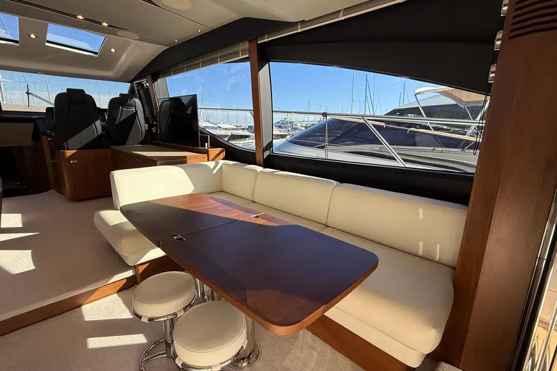 Stra Dodo Yacht Photos Pics Luxurious interior of 2019 Princess S65 yacht with elegant seating and wooden table.