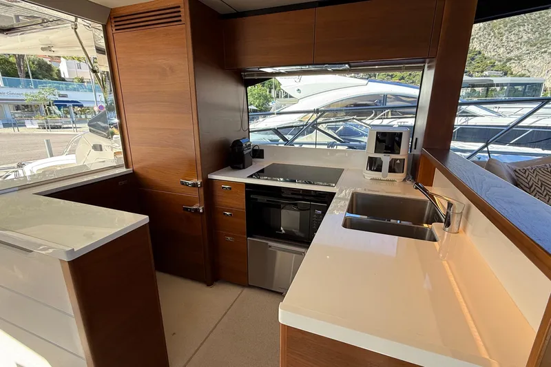 Stra Dodo Yacht Photos Pics Luxurious kitchen interior of 2019 Princess S65 yacht with modern appliances and sleek design.
