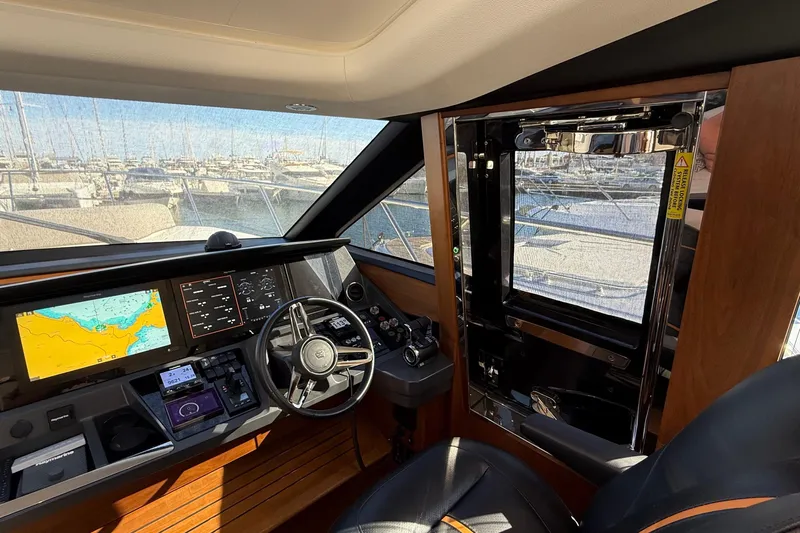 Stra Dodo Yacht Photos Pics 2019 Princess S65 yacht cockpit with navigation screens and steering wheel.
