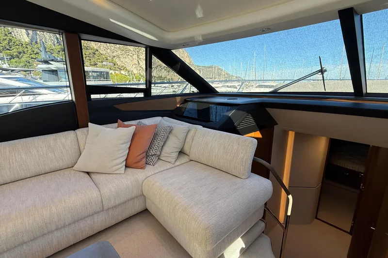 Stra Dodo Yacht Photos Pics Luxurious interior of 2019 Princess S65 yacht with plush seating and scenic marina view.