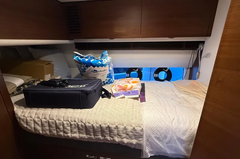 Stra Dodo Yacht Photos Pics Cozy cabin interior of 2019 Princess S65 yacht with bed and storage items.