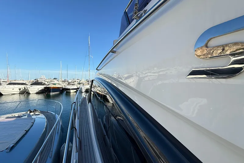 Stra Dodo Yacht Photos Pics 2019 Princess S65 yacht docked in a marina, surrounded by other luxury boats.