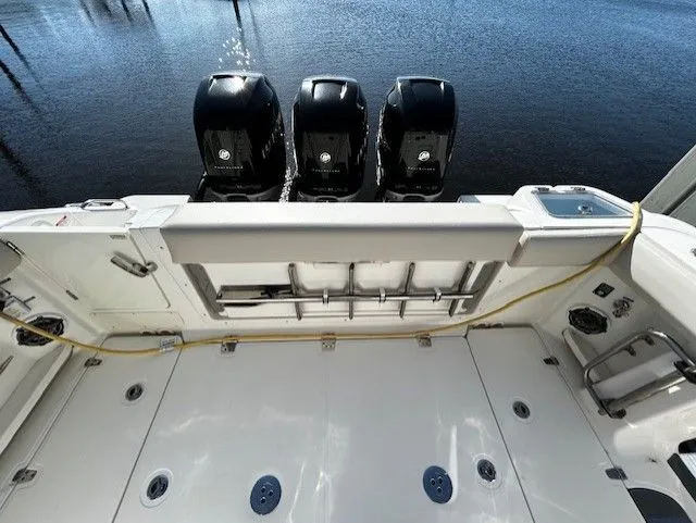  Yacht Photos Pics Boston Whaler 350 EX 2021 with three outboard engines by the water.