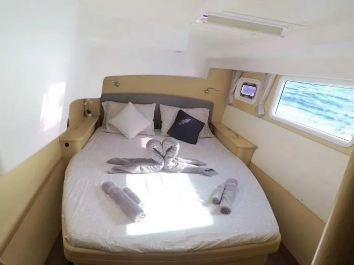 Katarina Yacht Photos Pics Cozy cabin interior of 2010 Lagoon 440 catamaran with bed and ocean view.