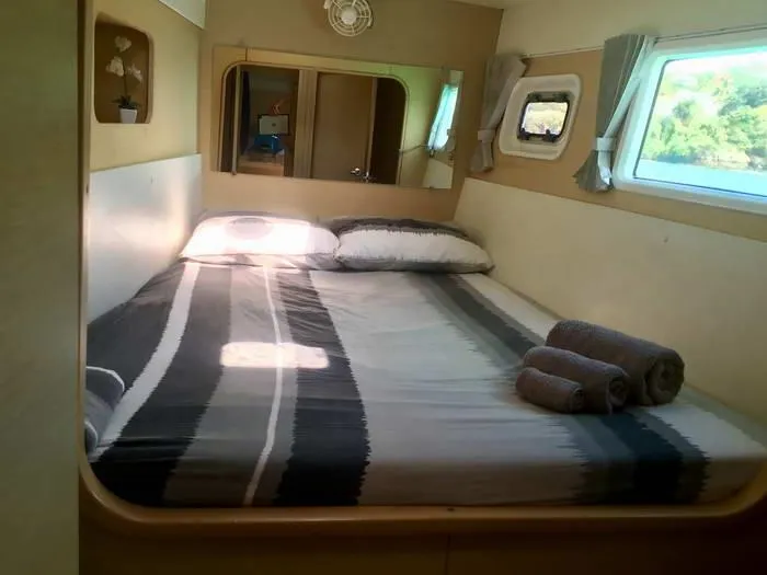 Katarina Yacht Photos Pics Cozy bedroom in 2010 Lagoon 440 catamaran with striped bedding and rolled towels.