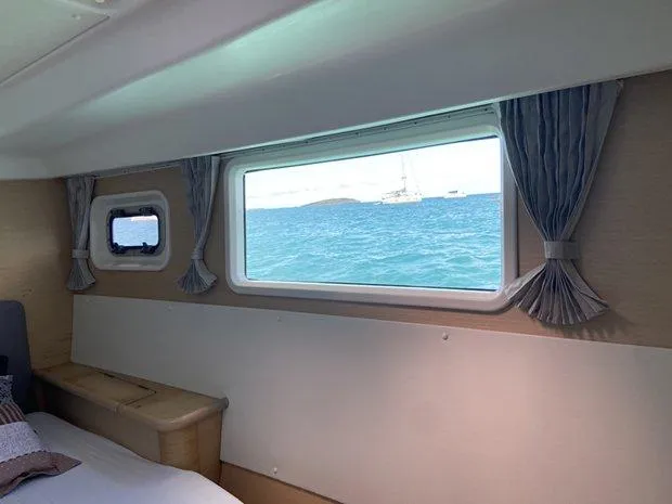Katarina Yacht Photos Pics Interior view of 2010 Lagoon 440 yacht cabin with ocean view through window.
