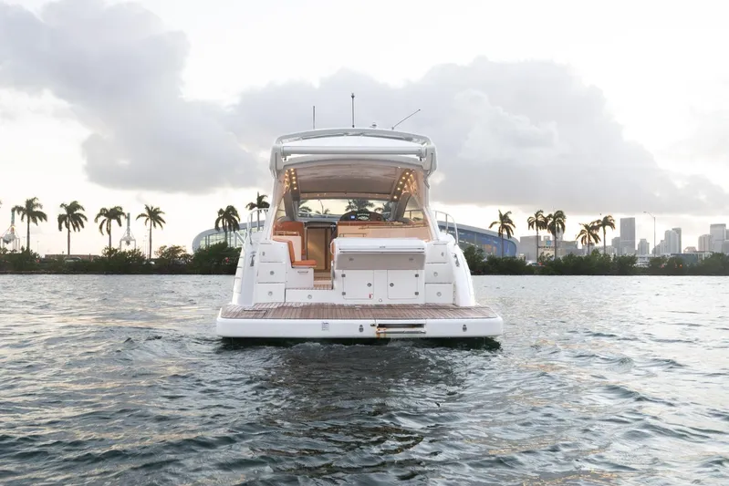  Yacht Photos Pics 2018 Schaefer 400 Sport yacht on water with city skyline and palm trees.