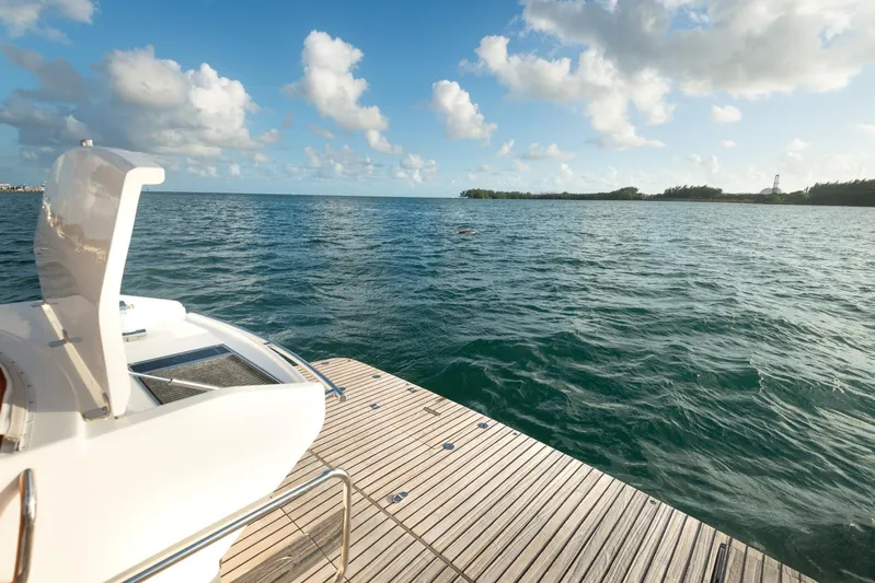  Yacht Photos Pics Schaefer 400 Sport 2018 yacht on a serene ocean with a wooden deck.