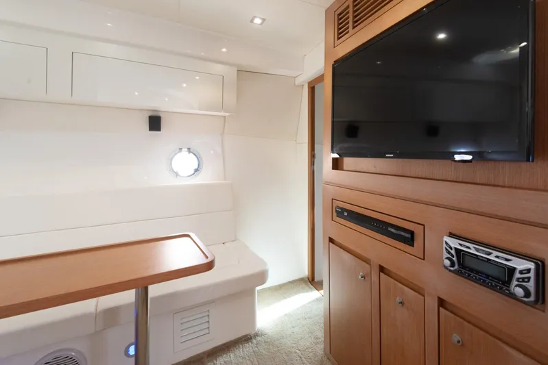  Yacht Photos Pics Interior of 2018 Schaefer 400 Sport yacht with TV, seating, and wooden cabinetry.
