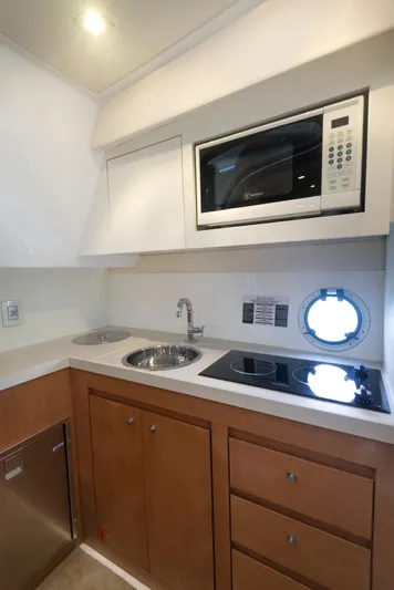  Yacht Photos Pics Compact kitchen area in a 2018 Schaefer 400 Sport yacht with microwave and sink.